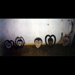 African mask in a village, mid 20th century.