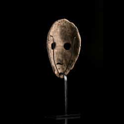 Back of Dan wooden mask showing perimeter attachment holes