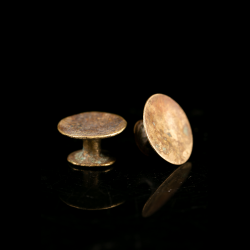 Antique West African bronze ear plugs with aged patina, probably Lobi or Akan tribal ornaments.