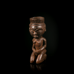 Front view of a Pende anthropomorphic wooden cup carved as a kneeling human figure.