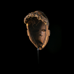 Rear view of an antique Pende Mbangu mask showing the woven fiber coiffure and interior patina.