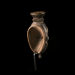 Rear view of a Baoulé Mblo mask from Ivory Coast with metal display stand.