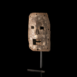 Traditional Kumu wooden mask from the Democratic Republic of the Congo, mounted on a display stand