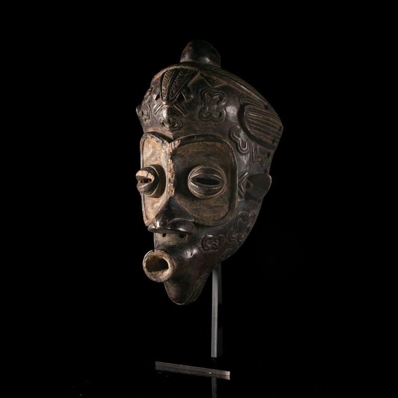 Bena Lulua wooden mask with carved geometric decoration and custom metal display stand.