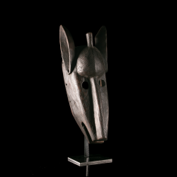 Bamana Kono wooden mask with tall upright ears displayed on its custom-made metal stand.