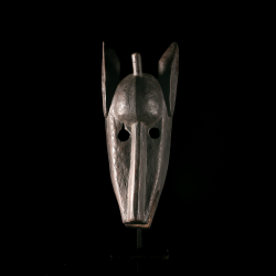Front view of a Bamana Kono mask featuring engraved geometric decoration.
