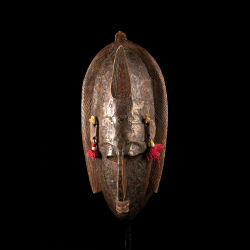 Front view of a Marka mask from Mali with engraved metal plating.
