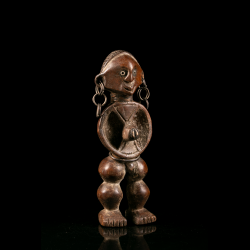 Three-quarter view of a Zande figure showing its distinctive circular torso carving.