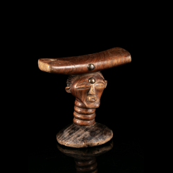 Anthropomorphic Songye headrest with curved cradle and metal studs