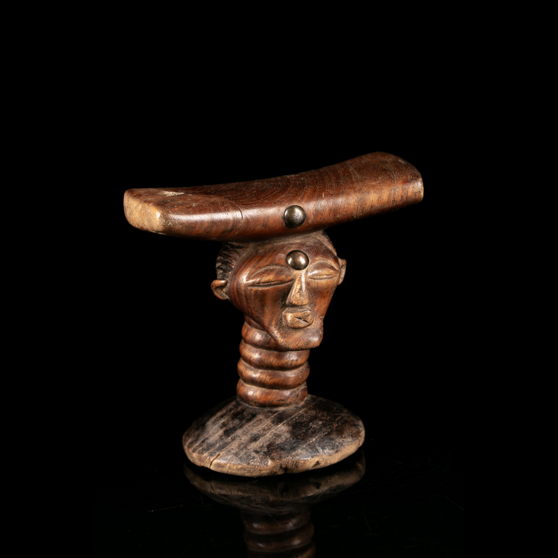 Anthropomorphic Songye headrest with curved cradle and metal studs