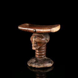 Songye wooden headrest with carved human head from the Congo