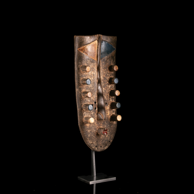 Geometric Grebo mask in carved wood and pigments – three-quarter view