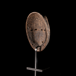 African Lega two-faced mask displayed on custom stand