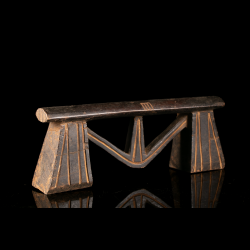 Zulu African wooden headrest with geometric supports and incised linear decoration, three-quarter view