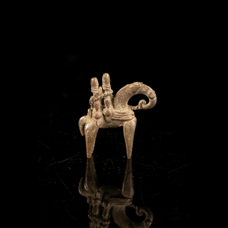 Small African Putchu Guinadji horseman with curled-tail horse, side view
